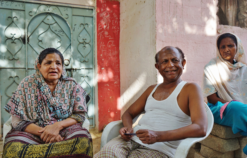 Mofiz Khan, 55, sits with his wife and neighbor in Orangi Town, a residential area suffering the worst of Karachi’s water crisis. Photo by Sabrina Toppa